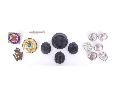 A collection bog oak, silver and enamel buttons and badges.A set of six Edwardian, Art Nouveau, silver buttons, relief decora