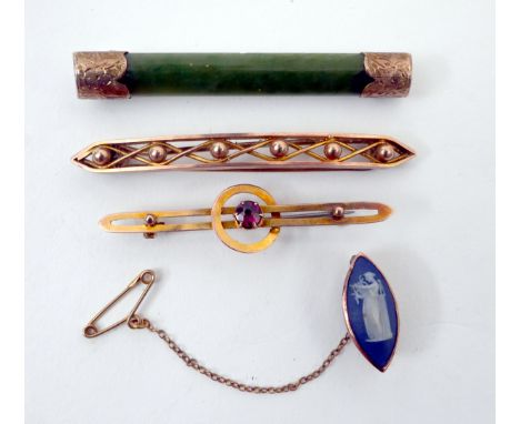 Gold brooches.A collection of mid-20th century gold-mounted brooches, including a 9ct gold and moss-green jade brooch, a 9ct 