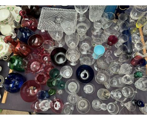 Assorted cranberry glass including vases and jugs, together with glass bottles, other glass vases, drinking glasses, blue gla