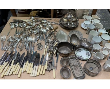 A large quantity of loose electroplated cutlery together with other electroplated wares including a bottle coaster, swing han