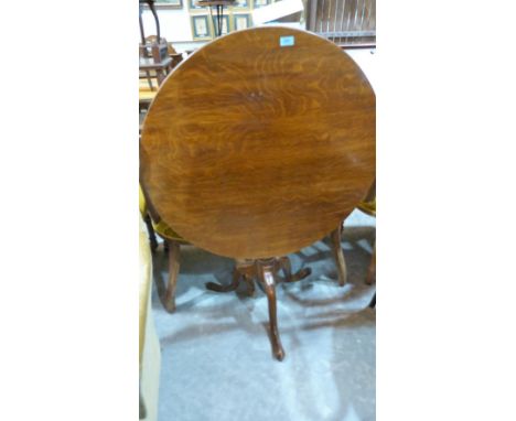 An oak snap-top tripod table. 32'' diameter