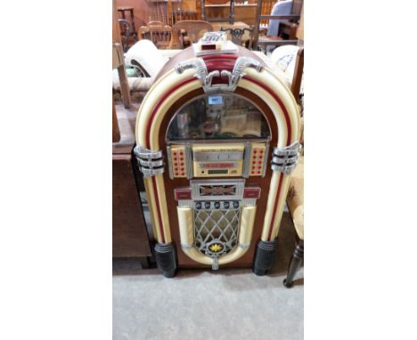 A juke box of recent manufacture with radio and playing CD's