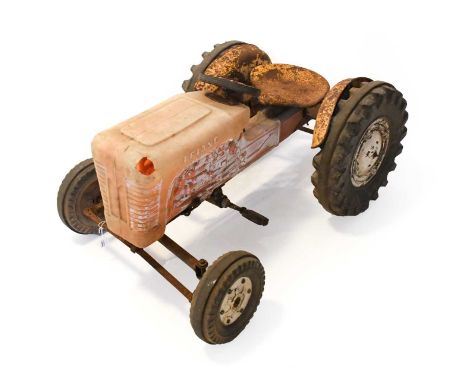 A 1960's Plastic Bodied Triang Pedal Tractor, the seat and later steering wheel above a moulded body and metal frame, with bl