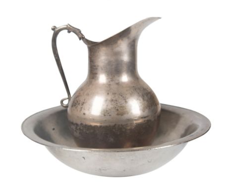 Large jug and basin in silver metal. Early 20th century.33 x 40 x 40 cm.
