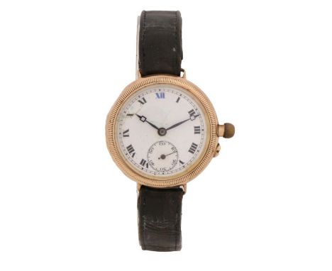 9 carat gold trench watch, the white enamel dial with Roman numerals and subsidiary seconds dial, manual wound, the case 32mm