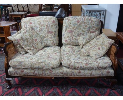 An early 20th century Queen Anne style burr walnut bergere sofa 