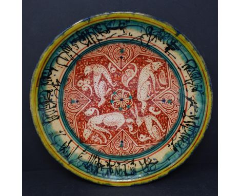 A Persian glazed ceramic plate, decorated with jackals from fables of a Buddhistic source translated into Pahlavi in the 6th 