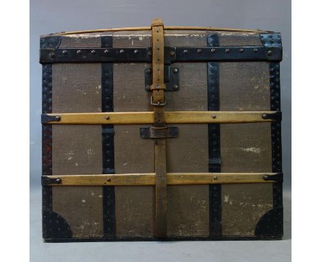 A late 19th/early 20th century French dome top travelling trunk, iron bound, with makers label, H.65 W.71 D.45cm 
