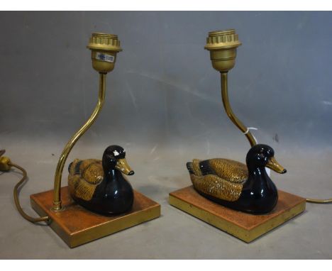 A pair of brass table lamps with ceramic models of ducks, with label tag for Christopher Wray 