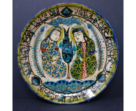 A Persian glazed ceramic plate, made in Tehran, date and makers mark to reverse, depicting a Persian love story of the Sasani