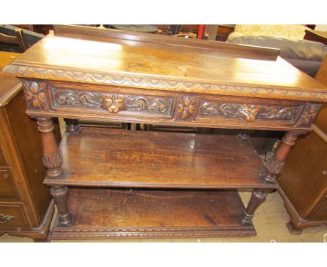 A 19th century Low Countries oak buffet with a rectangular carved top inset with drawers above a shelf and pot board 