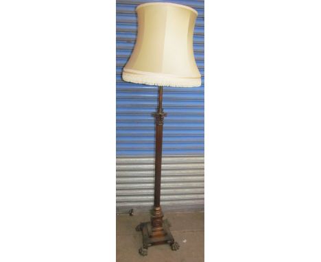 A copper telescopic standard lamp with a Corinthian column on a stepped square base and lions paw feet