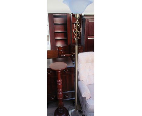 A brass standard lamp with a glass up lighter shade together with a torchere