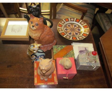 A Beswick cat together with a Royal Crown Derby porcelain plate, decorative cat figures, scent bottle and prints