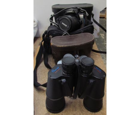 A Canon Eos 1000F 35mm camera together with a pair of Omiya 10 x 50 binoculars and a pair of Regent 8 x 30 binoculars