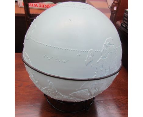 A braille globe on a black metal stand