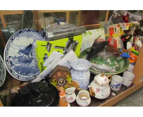 A large lot including a water basin, mugs, charger, toys, Coalport figures, mantle clock, etc