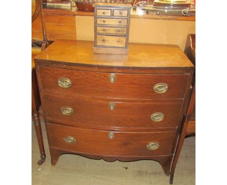 A George III mahogany chest, the D shaped top above three long drawers on splayed bracket feet, together with a miniature che