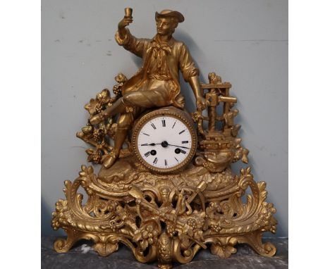 A gilt metal mantle clock with a figural surmount, the white enamel dial with Roman numerals