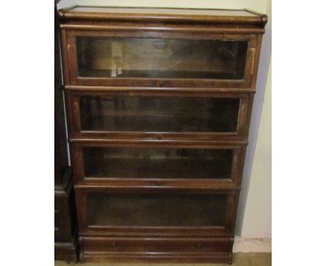 An oak four division Globe-Wernicke bookcase with glazed doors and a drawer to the base