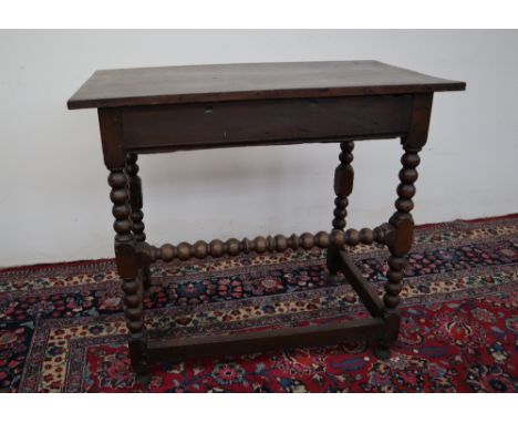 A 19th century oak side table, the rectangular top above a frieze drawer on bobbin turned legs united by stretchers, 82cm wid