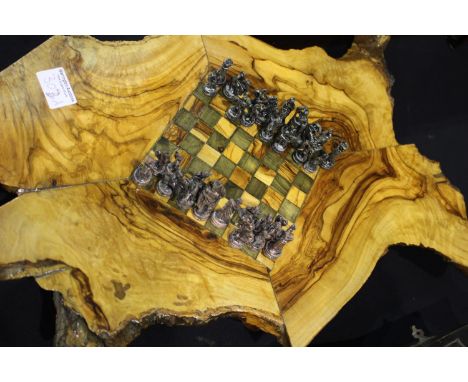 Metal chess set with Bishops as elephants, king H: 50 mm, on a large four part tree trunk hand made base, 52 x 33 cm. P&amp;P
