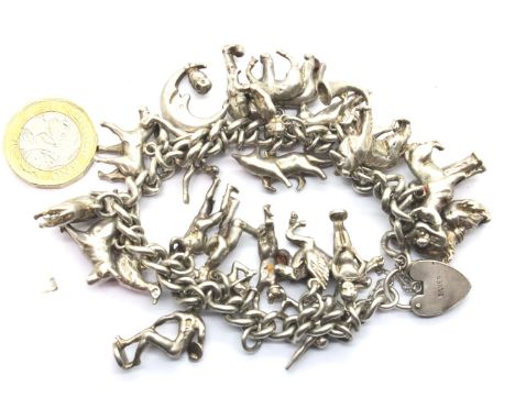 Heavy-gauge 925 Silver charm bracelet with 24 charms, L: 19 cm, 126g. P&amp;P Group 1 (£14+VAT for the first lot and £1+VAT f