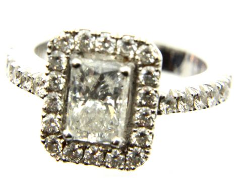 18ct white gold diamond set engagement ring, the central emerald-cut diamond of approximately 1.4cts surrounded by eighteen s