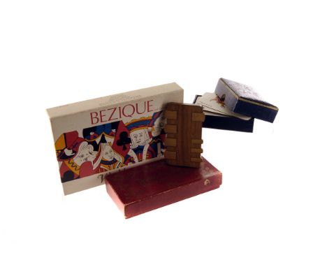 A collection of whist markers, from an assortment of makers and in various woods, with traditional playing cards for games of