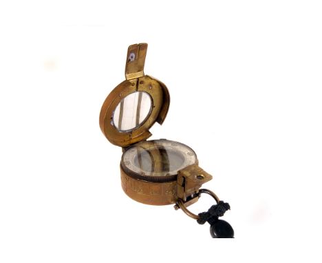 A WWII brass marching compass, marked with broad arrow, MKIII 1944, serial number E.A.C 258530