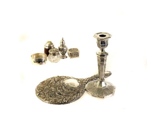 A collection of silver and white metal items, to include a filled silver candlestick, a silver hand mirror, two pepperettes, 