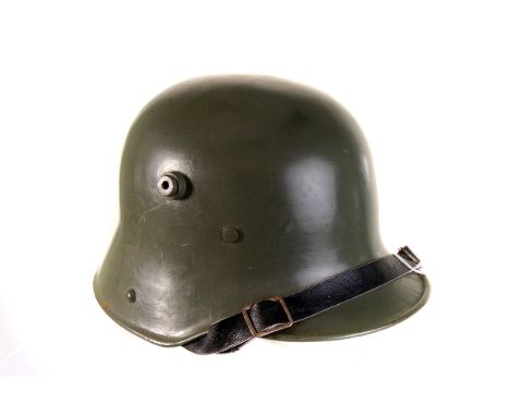 A modern military helmet, in the style of an M16, painted light green, possibly Chilean Army, with leather liner and front st