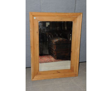 A pine wall Mirror with bevelled glass,  together with a modern pine wall shelf, mirror 118, shelf 67cm 