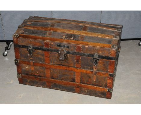A banded comed lidded trunk,  with leather cover, interior with inner shelf 92cm across