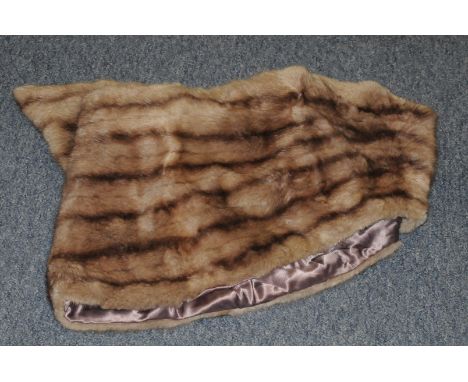 A fur shawl, made of light light brown coloured fur with satin lining