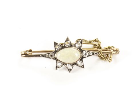 A vintage opal and cucic zirconia star brooch, on gold bar, approx 5g, with safety chain