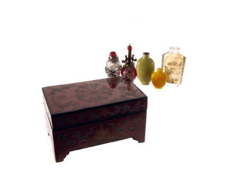 A red lacquer box, containing a collection of ceramic, glass, and stone snuff bottles (7)