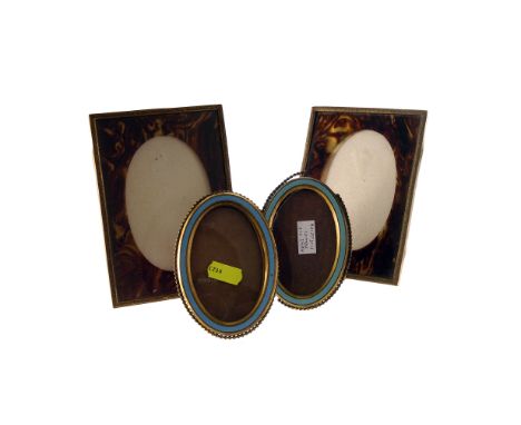 A pair of oval picture frames, with turquoise enamel bezels, plus a pair of faux tortoiseshell slip frames (4)