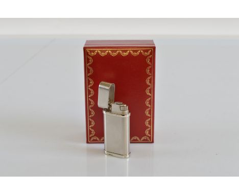 A Cartier white metal lighter, with box and leaflets, together with a pair of boxed Dunhill steel cufflinks (2)