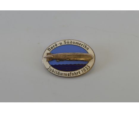 A Zeppelin: North and South America anniversary voyage in 1933 enamel oval brooch/badge, coloured in dark and light blue, sur