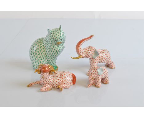 Four Herend figures, including an elephant with raised trunk, one tusk af, 14cm, a small elephant calf, 5.5cm, a model of a s