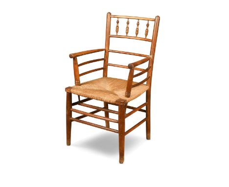 Attributed to Philip Webb for Morris & Co., an ash Sussex chair, with four spindle balustrade over turned open arms and strin