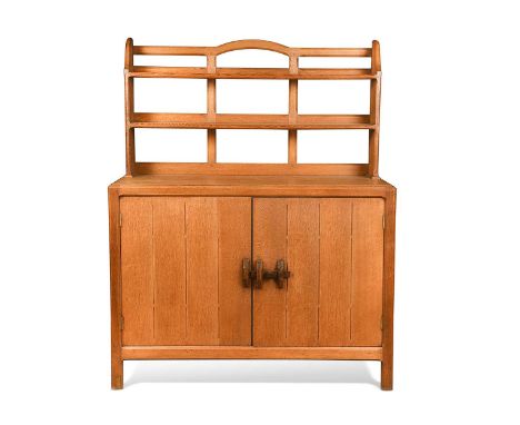 Attributed to Arthur Romney Green (1872-1945), an oak dresser, circa 1925, with open lattice shelves or plate rack with expos