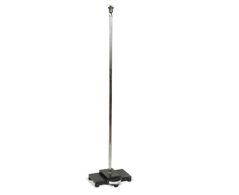 An Art Deco chrome standard lamp, circa 1930, the chromed tubular stem raised on a black-painted stepped wooden base incorpor