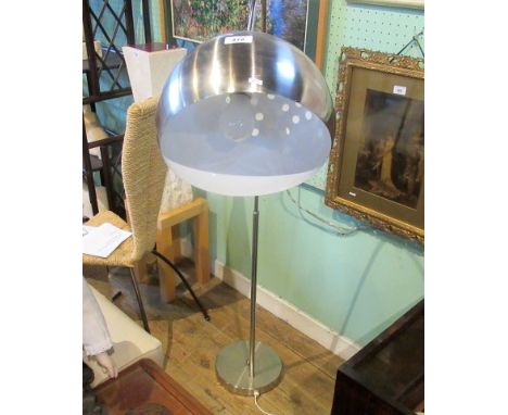 A contemporary chrome standard lamp with pierced domed shade.