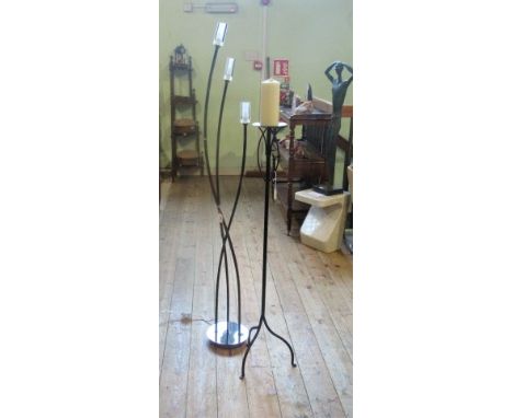 A contemporary black metal three light standard lamp, together with a black painted candle stand.