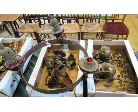 A 19th century wrought metal ceiling light, having three peripheral and one central ruby glass reservoir, now converted to el