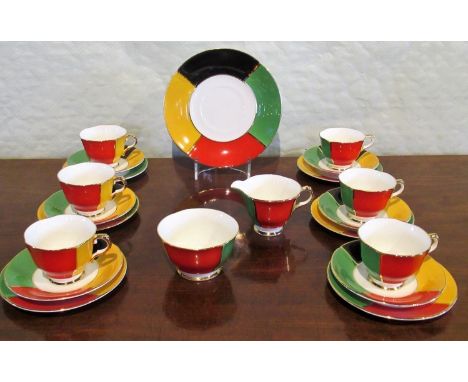 A 20th century Sutherland bone china part-tea service, each boldly decorated with panels of red, green, yellow and black on a