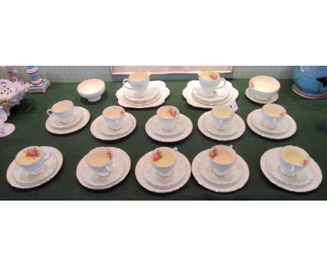 An early 20th century Foley bone china tea service, comfortably a ten place setting, each transfer decorated with pink roses 