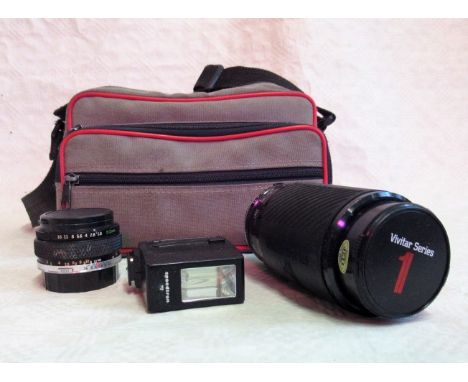 A Vivitar Zoom series I 70-210mm lens, together with an Olympus wide angle 50mm lens in a canvas camera case.